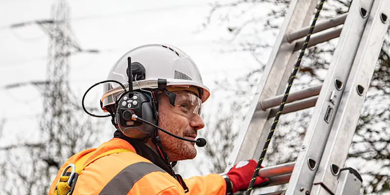 Male on ladder wearing hearing protection