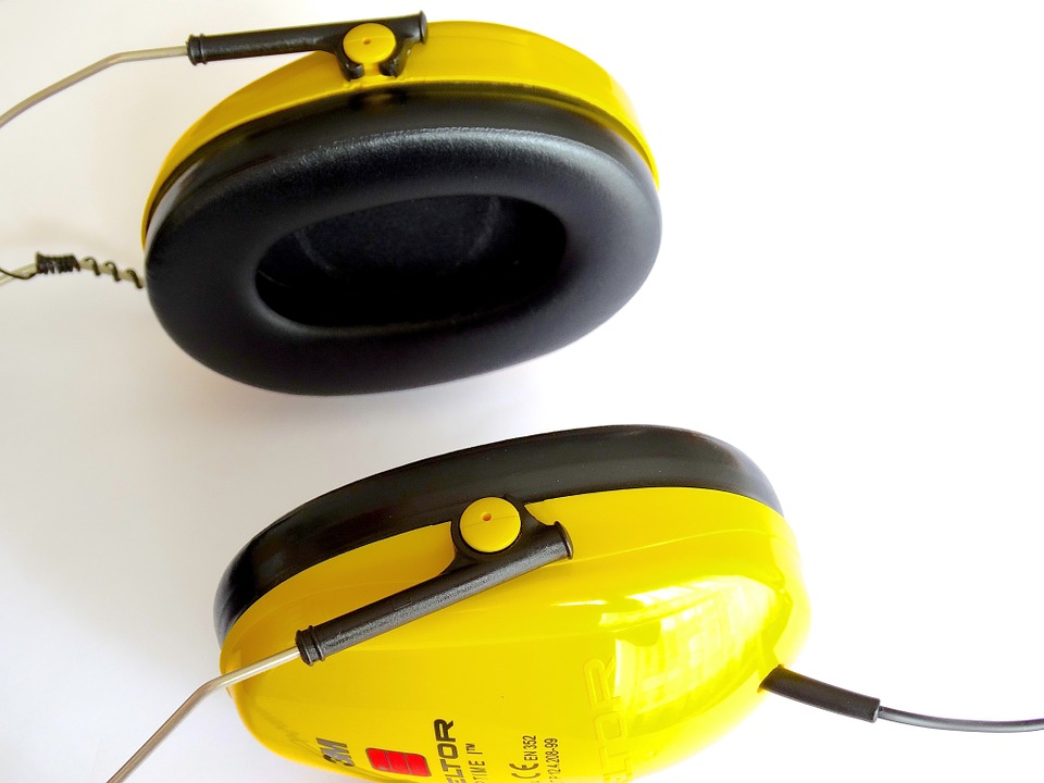 Yellow ear defenders to protect hearing at work 