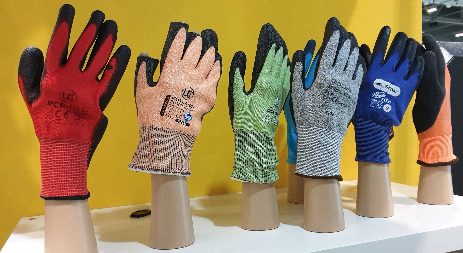 Display of red, orange, green, light blue, royal blue and peach work gloves