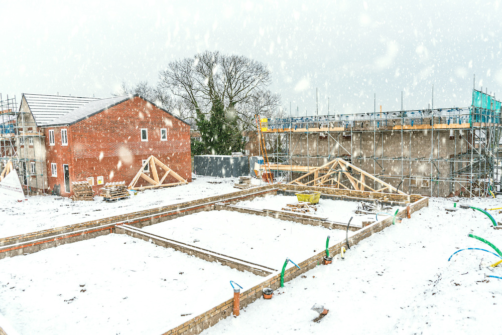 Small house building site covered in ice and snow