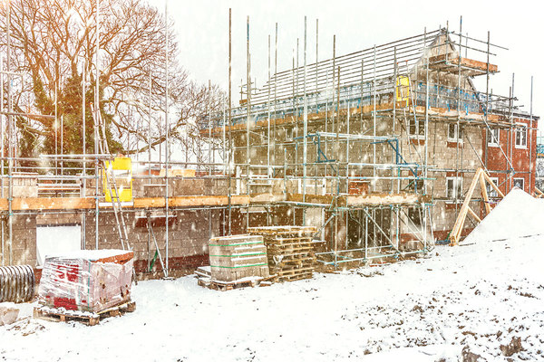 House with scaffolding and an extension  being built during winter months