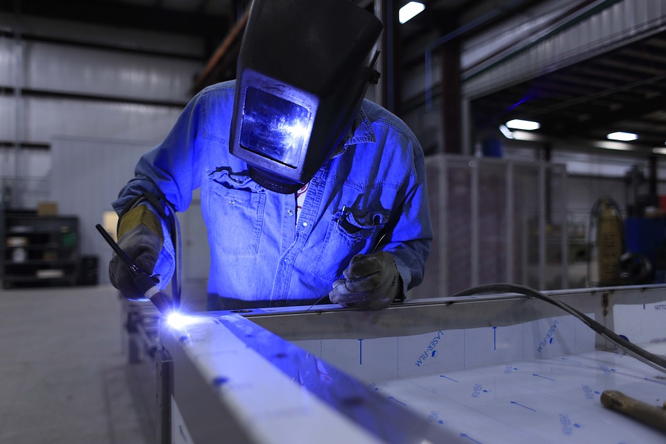 Male wearing full face mask and overalls while working