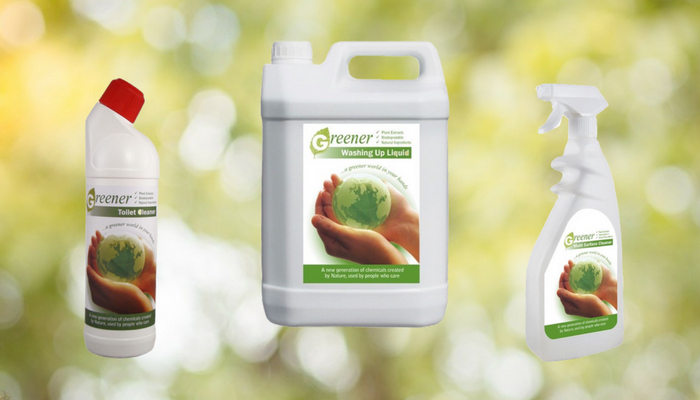 Range of eco-friendly cleaning products on green background